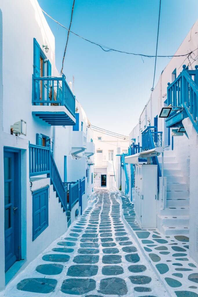 Empty white washed and blue trim street of Mykonos, Greece